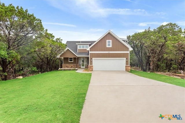 craftsman inspired home featuring a front yard and a garage