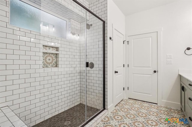 bathroom with tile patterned flooring, vanity, and a shower with shower door