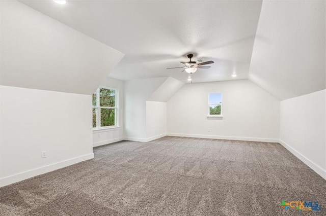 bonus room featuring a wealth of natural light, lofted ceiling, and ceiling fan