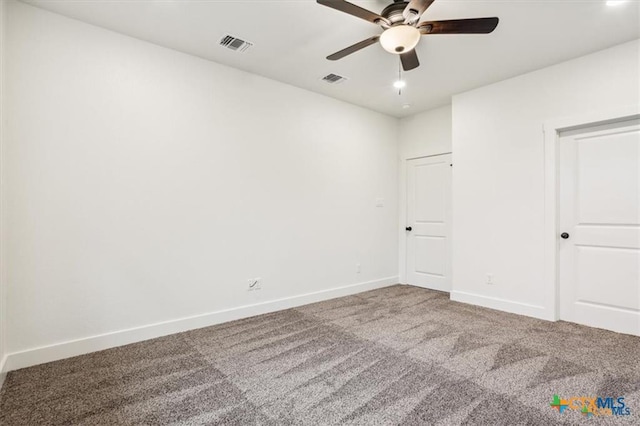 carpeted spare room featuring ceiling fan