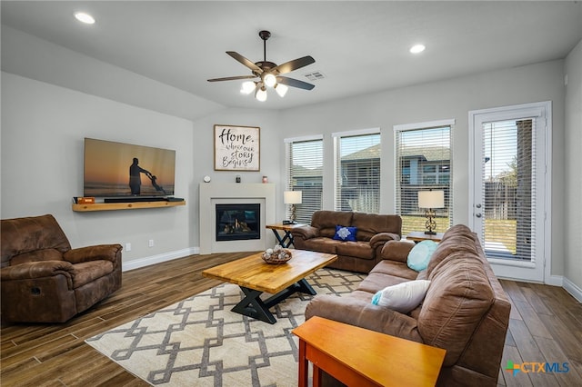 living area featuring visible vents, a ceiling fan, wood finished floors, recessed lighting, and baseboards