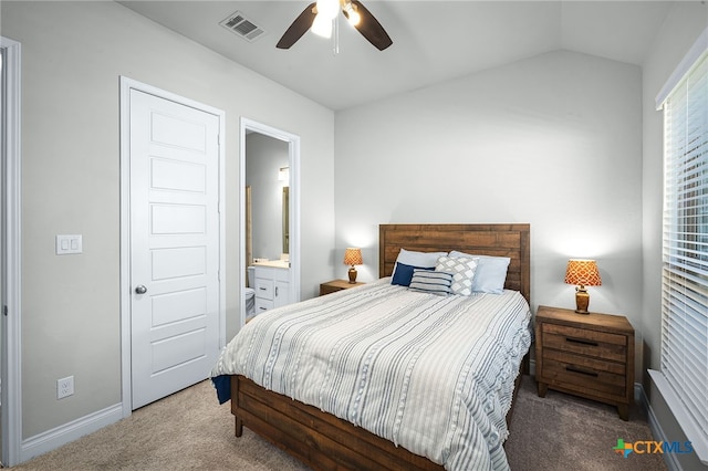 carpeted bedroom featuring visible vents, ensuite bath, baseboards, lofted ceiling, and ceiling fan