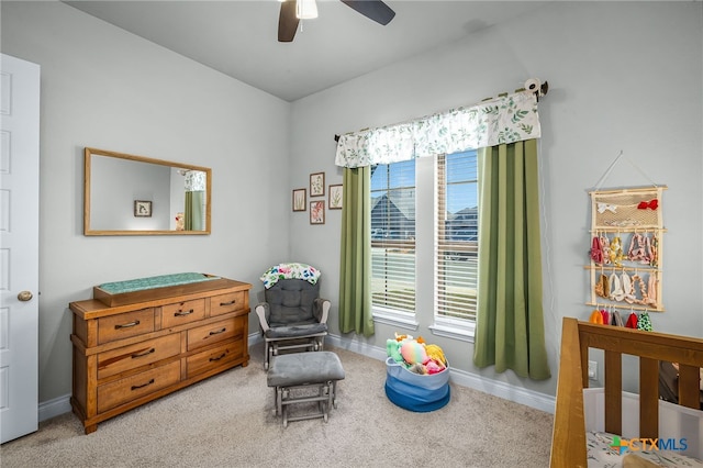 bedroom with a ceiling fan, baseboards, and carpet floors