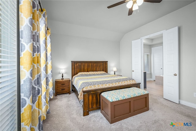 bedroom with light carpet, ceiling fan, baseboards, and lofted ceiling