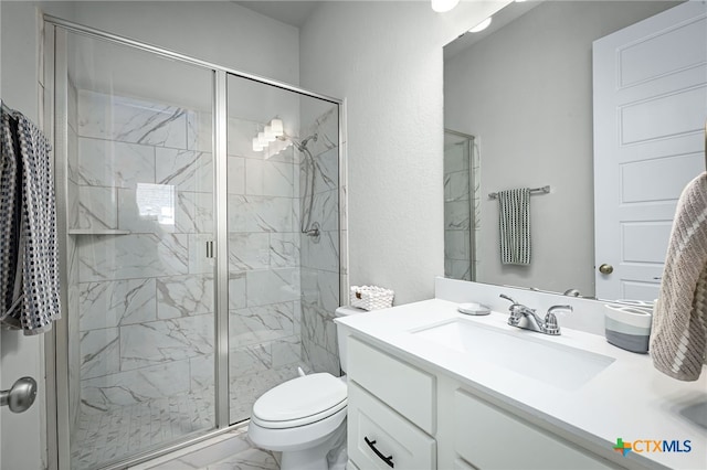 bathroom featuring vanity, toilet, marble finish floor, and a marble finish shower