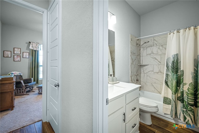 full bath with shower / tub combo with curtain, wood finished floors, vanity, and toilet