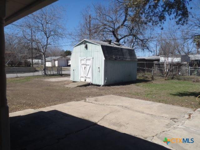 view of shed featuring fence