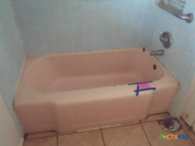 bathroom with a bathtub and tile patterned floors