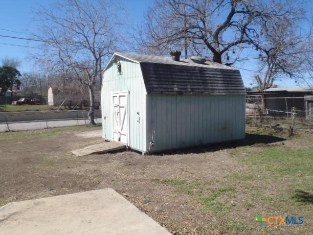 view of shed with fence