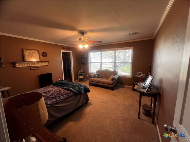 bedroom featuring carpet flooring, ceiling fan, and crown molding