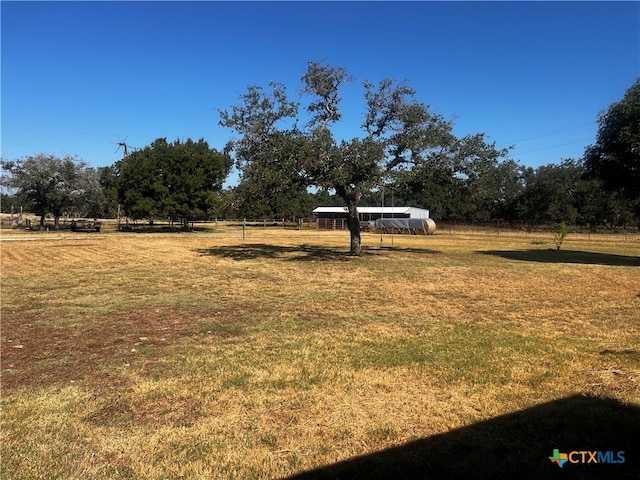 view of yard with a rural view