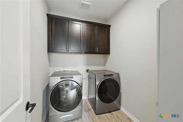 117 Ace Ln Unit 101, San Marcos, TX 78666 - laundry area featuring cabinet space, independent washer and dryer, and light wood-style floors