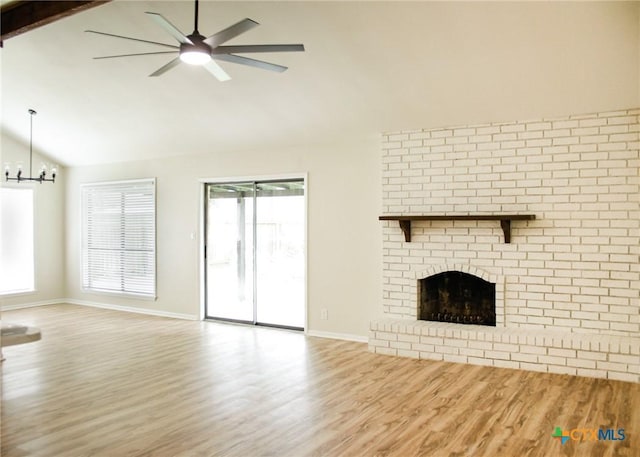 211 Alamogordo Dr, Victoria, TX 77904 - unfurnished living room with ceiling fan, wood finished floors, a fireplace, a chandelier, and beam ceiling