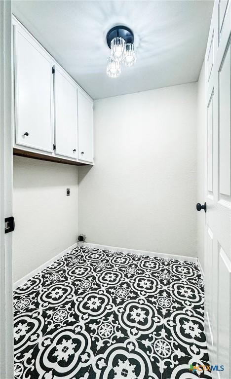 211 Alamogordo Dr, Victoria, TX 77904 - laundry area featuring electric dryer hookup, cabinet space, and a chandelier
