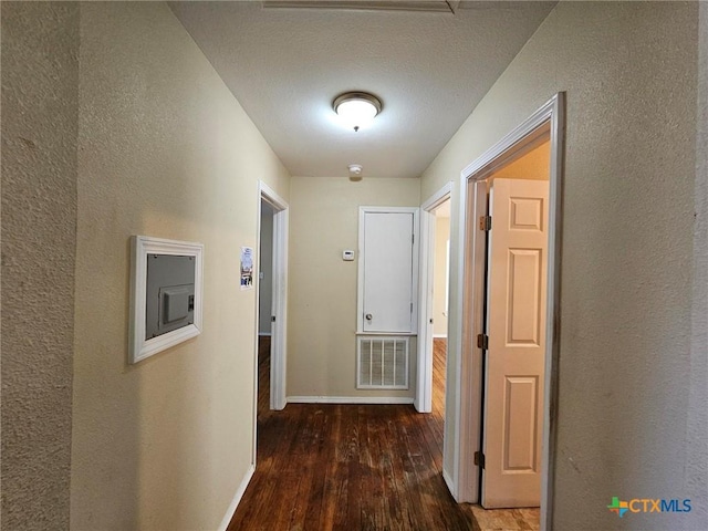 hallway featuring dark hardwood / wood-style flooring