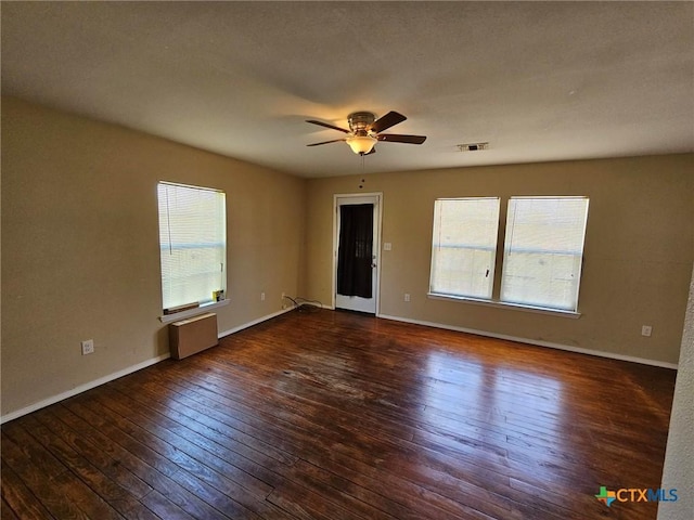 spare room featuring ceiling fan and dark hardwood / wood-style flooring