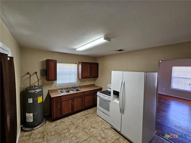 kitchen with a textured ceiling, electric water heater, sink, and white appliances