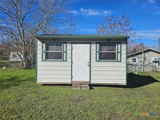 view of outbuilding featuring a yard