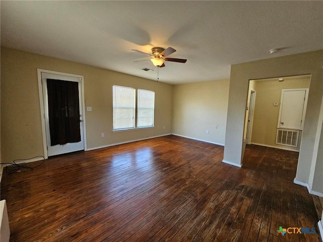 unfurnished living room featuring ceiling fan and dark wood-type flooring