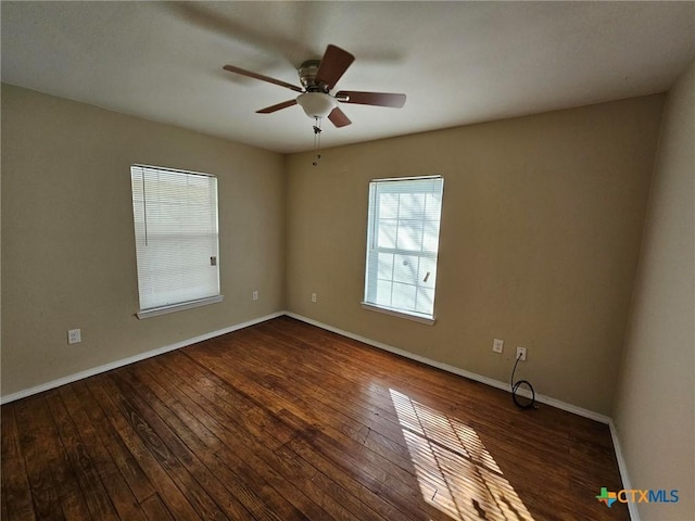 empty room with ceiling fan and dark wood-type flooring