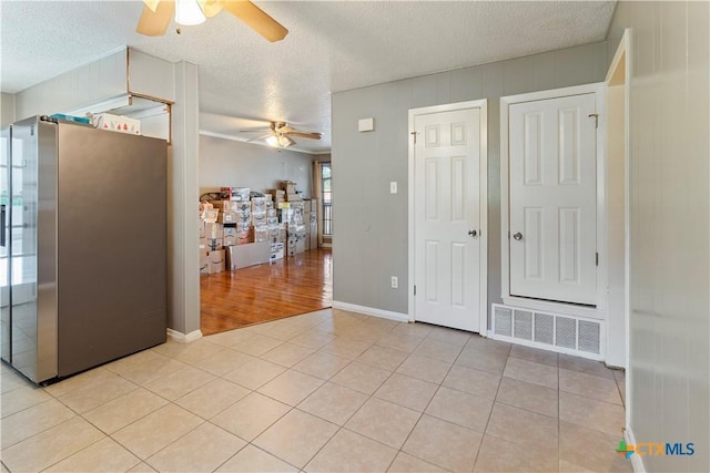 806 S 23rd St, Copperas Cove, TX 76522 - spare room featuring a ceiling fan, a textured ceiling, light tile patterned floors, and baseboards