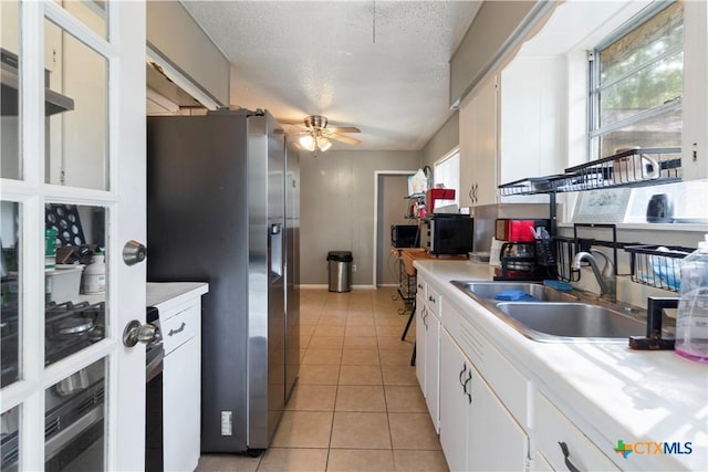 806 S 23rd St, Copperas Cove, TX 76522 - kitchen with stainless steel refrigerator with ice dispenser, a sink, light countertops, a ceiling fan, and a textured ceiling