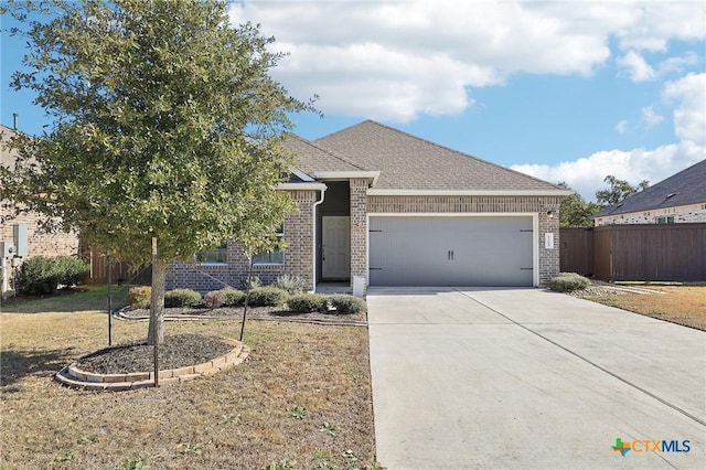 view of front of property featuring a front lawn and a garage