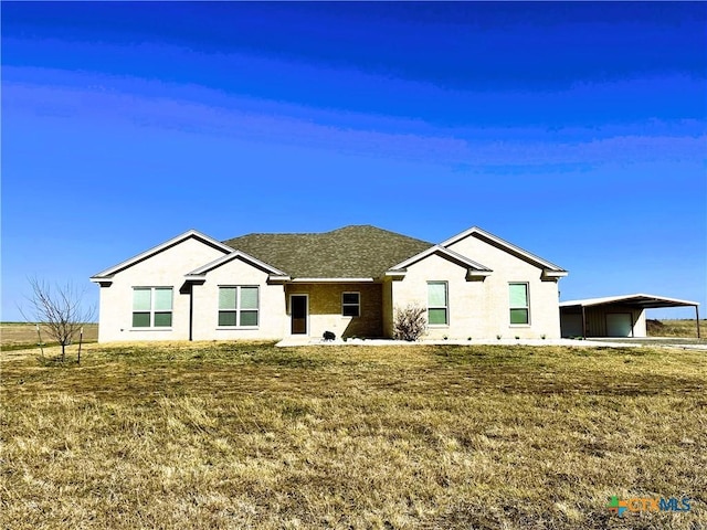 ranch-style house featuring a carport and a front yard