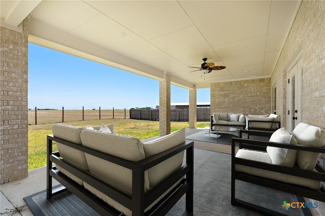 view of patio with outdoor lounge area and ceiling fan