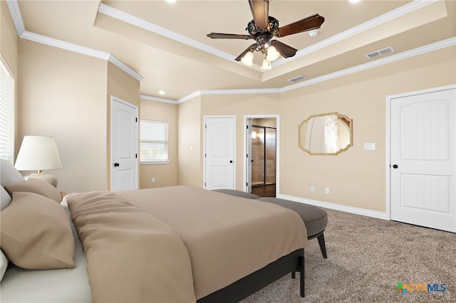 bedroom with crown molding, a tray ceiling, and carpet floors