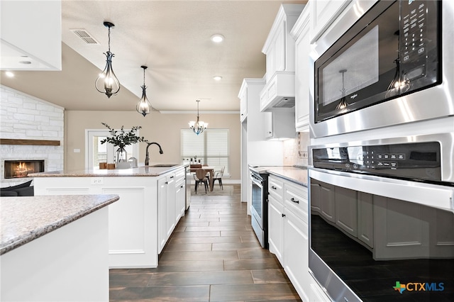 kitchen featuring pendant lighting, appliances with stainless steel finishes, and white cabinets