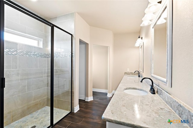 bathroom with vanity, wood-type flooring, and a shower with door