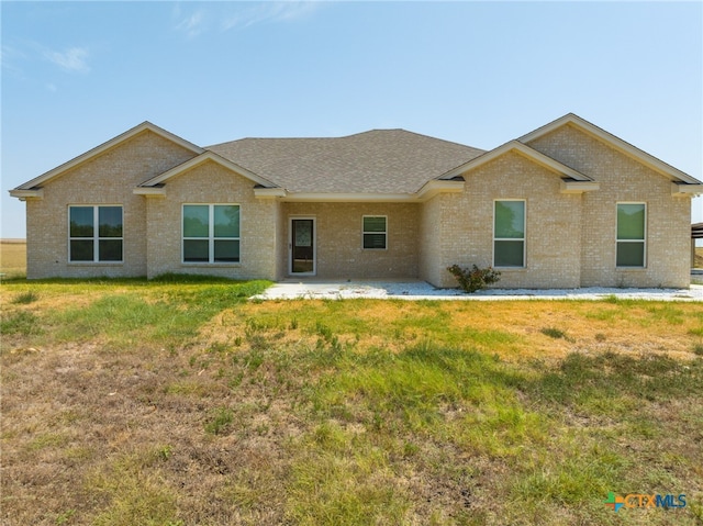 rear view of house with a lawn