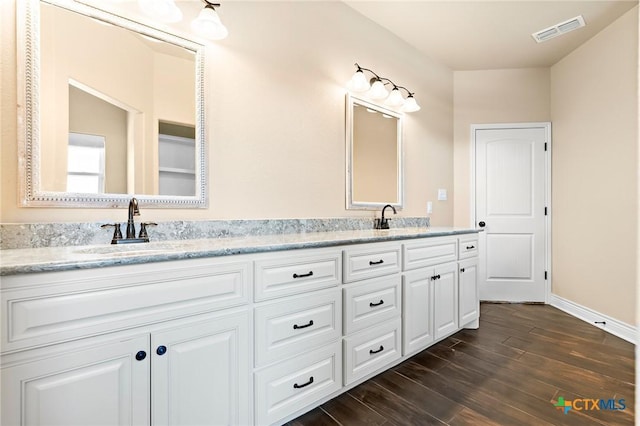 bathroom with vanity and wood-type flooring