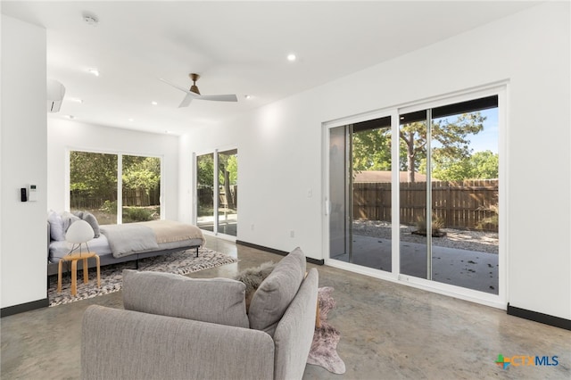 105 Schroeder St, Lockhart, TX 78644 - bedroom featuring recessed lighting, baseboards, access to outside, and finished concrete floors