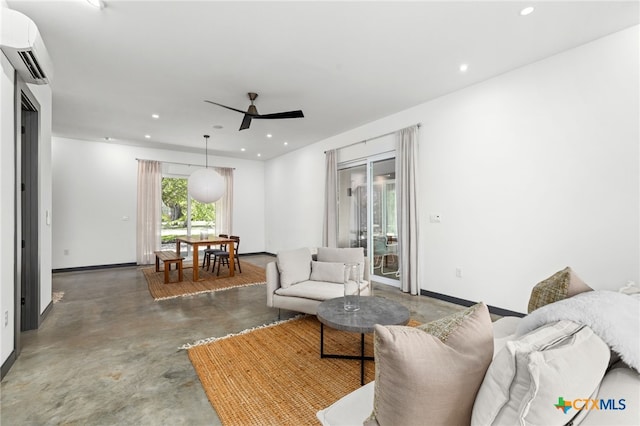 105 Schroeder St, Lockhart, TX 78644 - living area with a wall mounted air conditioner, finished concrete floors, ceiling fan, baseboards, and recessed lighting