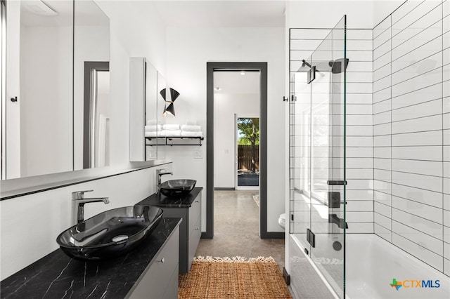 105 Schroeder St, Lockhart, TX 78644 - bathroom with tiled shower / bath combo, double vanity, and a sink