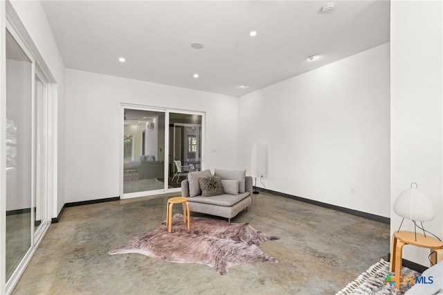 105 Schroeder St, Lockhart, TX 78644 - living area featuring baseboards, recessed lighting, and finished concrete flooring