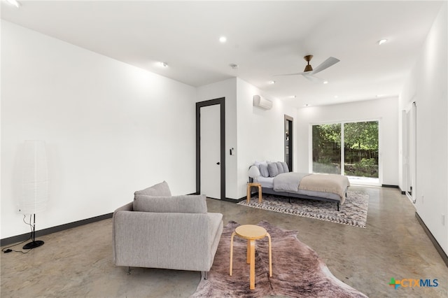 105 Schroeder St, Lockhart, TX 78644 - bedroom featuring baseboards, finished concrete floors, recessed lighting, and a wall mounted air conditioner