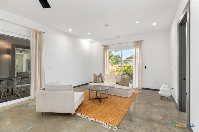 105 Schroeder St, Lockhart, TX 78644 - living area featuring baseboards, recessed lighting, and finished concrete flooring