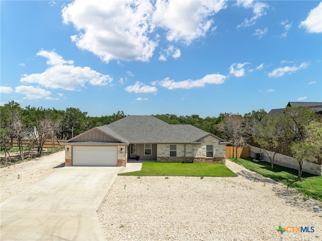 ranch-style house with a garage and a front yard