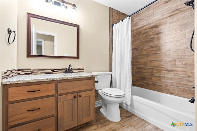 full bathroom featuring vanity, hardwood / wood-style flooring, toilet, and shower / bathtub combination with curtain