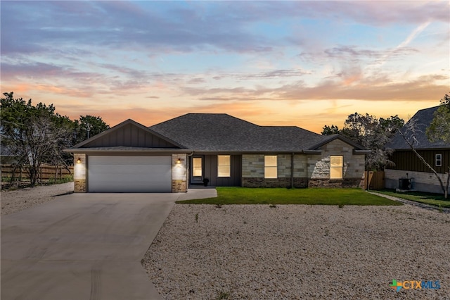 view of front of property with a garage and a lawn