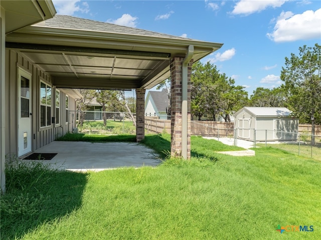 view of yard with a storage shed and a patio area