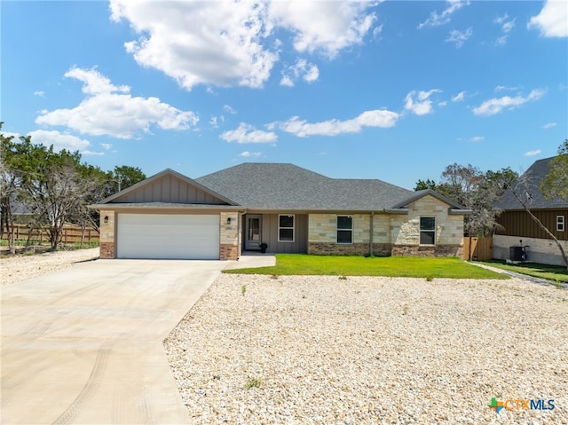 single story home featuring a garage and a front lawn