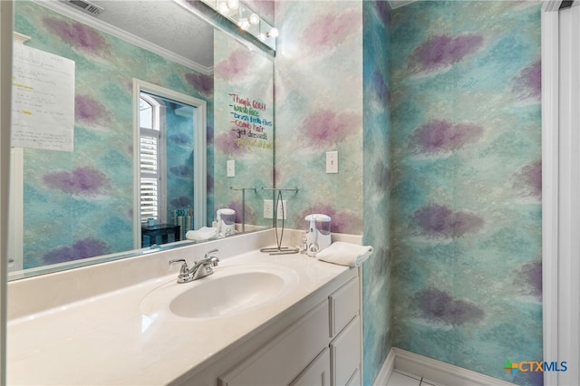 bathroom featuring vanity, a textured ceiling, and crown molding