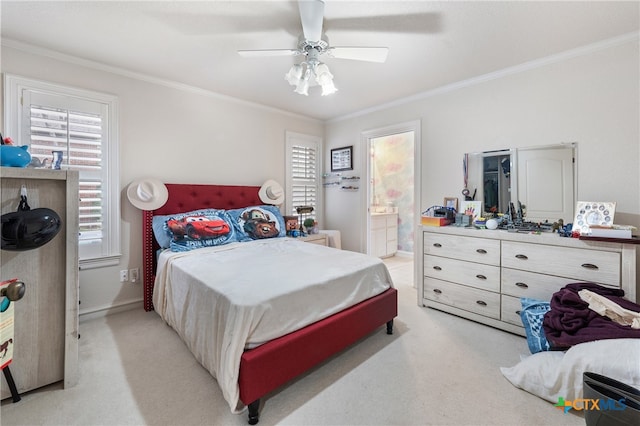 bedroom featuring light colored carpet, ensuite bath, ceiling fan, and crown molding