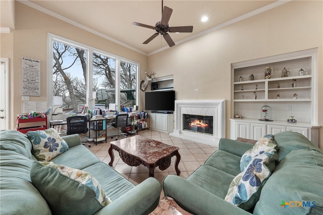 tiled living room with ceiling fan and ornamental molding