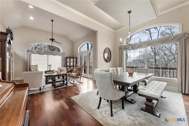 dining area featuring dark hardwood / wood-style floors, crown molding, ceiling fan with notable chandelier, and high vaulted ceiling