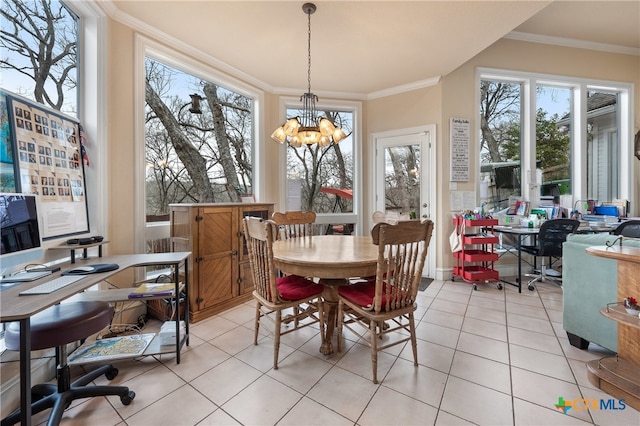 dining space with light tile patterned flooring, ornamental molding, and an inviting chandelier